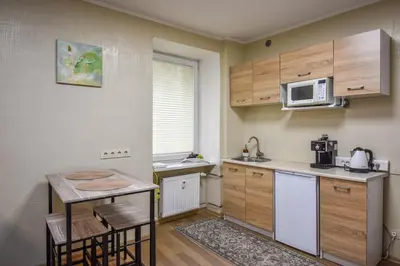 a small kitchen with a table and a microwave at A cozy apartment with private entrance in the city centre in Panevėžys