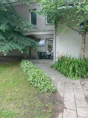 a house with a walkway in front of a yard at A cozy apartment with private entrance in the city centre in Panevėžys
