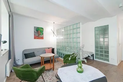 a living room with a couch and a table at Gate of Dawn Old town in Vilnius