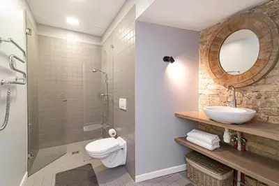 a bathroom with a sink and a toilet and a mirror at Gate of Dawn Old town in Vilnius