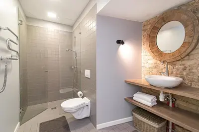 a bathroom with a sink toilet and a mirror at Gate of Dawn Old town in Vilnius