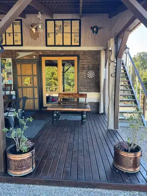 a wooden porch with a bench on a deck at Piliakalnio Apartmentai in Kupiškis