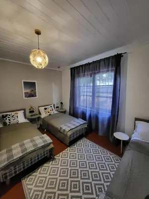 a bedroom with two beds and a window at Piliakalnio Apartmentai in Kupiškis