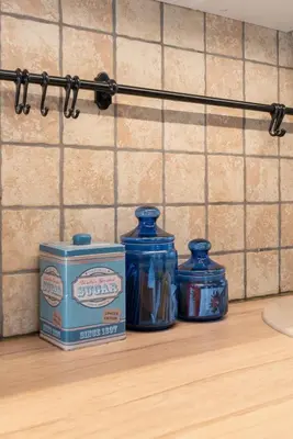 three blue jars sitting on top of a kitchen counter at Cozy Urban Apartment in Vilnius