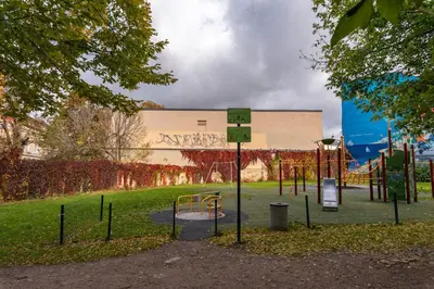 a park with a playground in front of a building at Cozy Urban Apartment in Vilnius