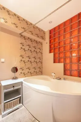 a bathroom with a tub and a sink at Cozy Urban Apartment in Vilnius