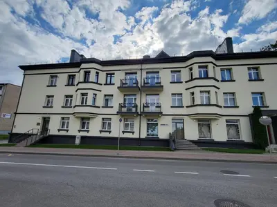 a large white building on the side of a street at Siauliai Apartments - Traku in Šiauliai