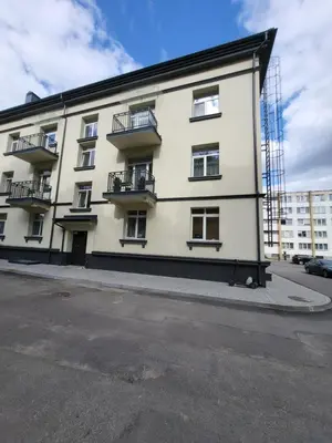 a white building with balconies on the side of it at Siauliai Apartments - Traku in Šiauliai