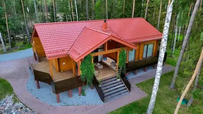 a small house with a red roof in the woods at Lake terrace