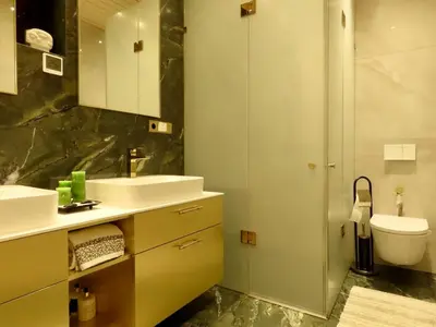 a bathroom with two sinks and a toilet and a shower at Lake terrace