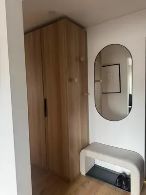 a bathroom with a mirror and a wooden cabinet at Studio Apartment with Balcony in Central Druskininkai in Druskininkai