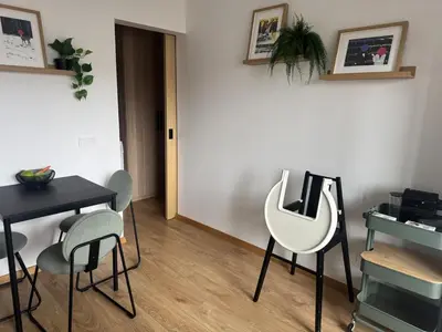 a room with a desk and two chairs and a table at Studio Apartment with Balcony in Central Druskininkai in Druskininkai