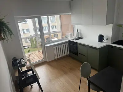 a small kitchen with a view of a balcony at Studio Apartment with Balcony in Central Druskininkai in Druskininkai