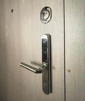 a metal door with a handle on a door at Apartment 52 in Kaunas