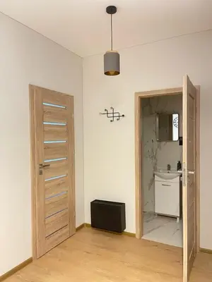 a room with a door leading to a kitchen at Apartment 52 in Kaunas