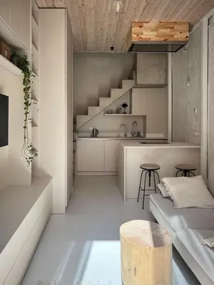 a kitchen and living room with stairs and a table at Designer studio in Vilnius
