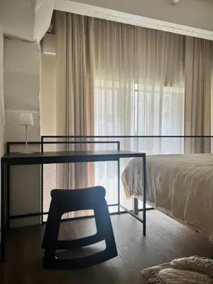 a bedroom with a desk and a bed and a chair at Designer studio in Vilnius