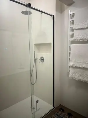a shower with a glass door in a bathroom at Designer studio in Vilnius