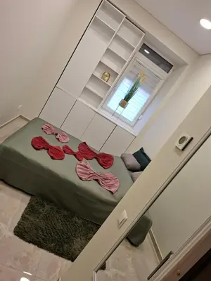 a room with a bed with red roses on it at Luxury center in Kaunas