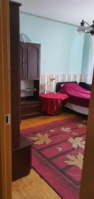 a room with a bed and a red rug at Cozy room with balcony in Visaginas in Visaginas