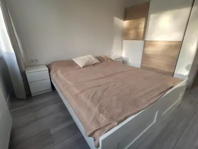 a bedroom with a large bed with a brown blanket at Rasa in Marijampolė