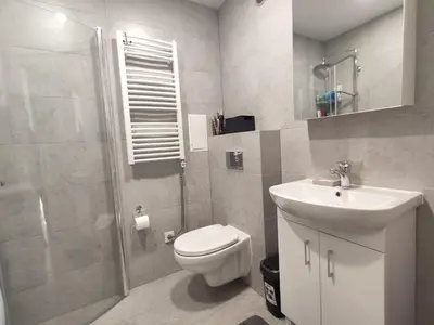 a bathroom with a toilet and a sink and a shower at Rasa in Marijampolė