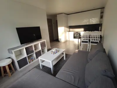 a living room with a couch and a table at Rasa in Marijampolė