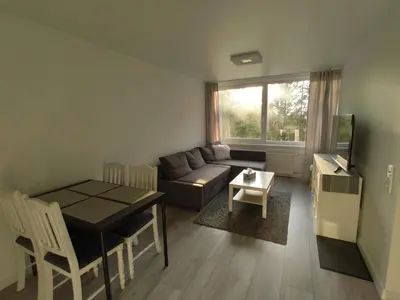 a living room with a couch and a table at Rasa in Marijampolė