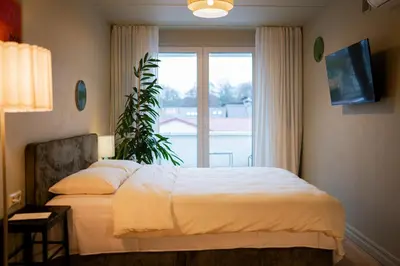 a bedroom with a bed and a large window at Pievos in Birštonas