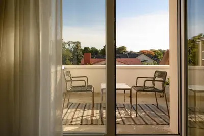 a view of a balcony with two chairs and a table at Pievos in Birštonas