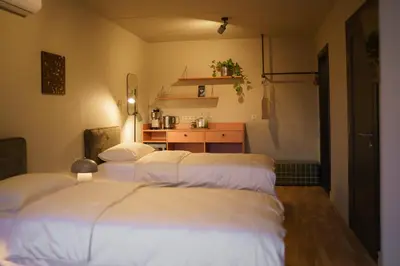 a room with four beds and a kitchen in it at Pievos in Birštonas