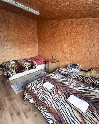 two beds sitting in a room with at Sodyba prie Mūšos
