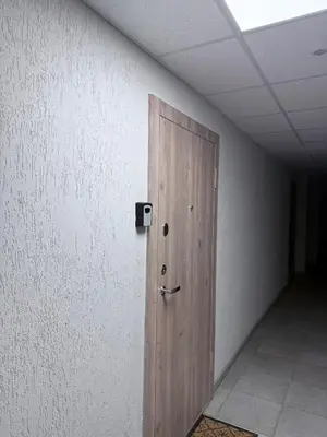 a wooden door in a room with a wall at EVA apartment in Marijampolė