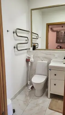 a bathroom with a white toilet and a mirror at Old town studio in Kaunas