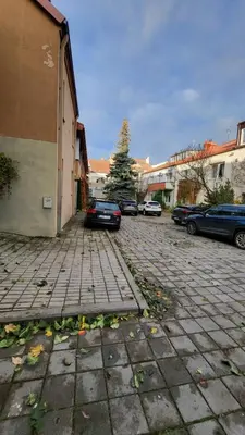 a parking lot with cars parked next to a building at Old town studio in Kaunas