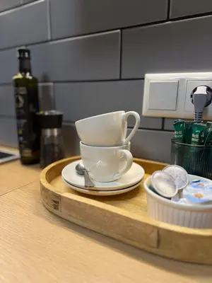 a coffee cup and saucer on a wooden tray at Feels like home in Visaginas
