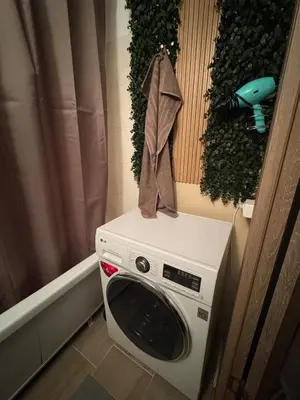 a washing machine with a towel on top of it at Feels like home in Visaginas