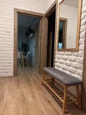 a bench sitting in a room with a mirror at Feels like home in Visaginas