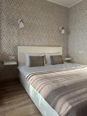 a large bed in a bedroom with a wall at Feels like home in Visaginas