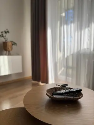 a remote control sitting on top of a wooden table at Feels like home in Visaginas