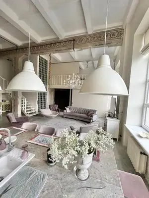 a living room with two large white pendant lights at Kaunas Design Loft in Kaunas