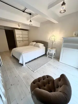 a bedroom with a bed and a couch in it at Kaunas Design Loft in Kaunas