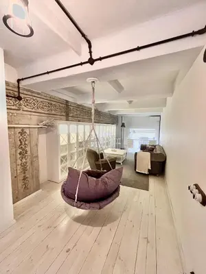 a room with a hammock in the middle of a room at Kaunas Design Loft in Kaunas
