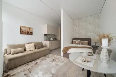a living room with a couch and a bed at Šopeno Butas Comfort & Relax in Old Town 2 in Vilnius