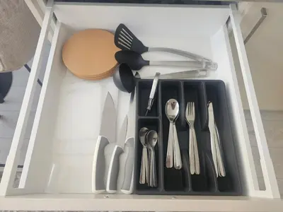 a drawer filled with utensils and utensils at Šopeno Butas Comfort & Relax in Old Town 2 in Vilnius