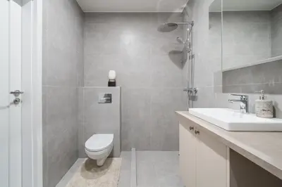 a bathroom with a toilet and a sink at Šopeno Butas Comfort & Relax in Old Town 2 in Vilnius
