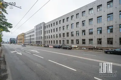 an empty street in front of a large building at Vytenio Loft - Serenity and Style in City Centre 23 in Vilnius