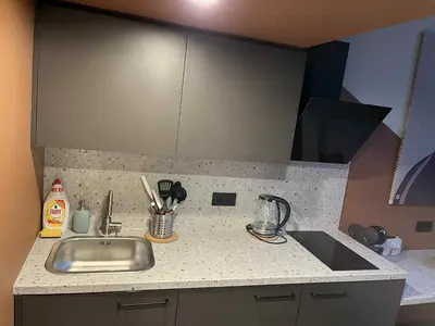 a kitchen counter top with a sink and a counter top at Vytenio Loft - Serenity and Style in City Centre 23 in Vilnius