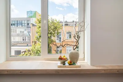 a window with a bowl of fruit in front of it at Vytenio Loft - Serenity and Style in City Centre 23 in Vilnius