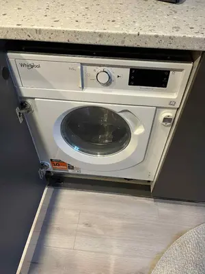 a washing machine in a kitchen with a counter at Vytenio Loft - Serenity and Style in City Centre 23 in Vilnius